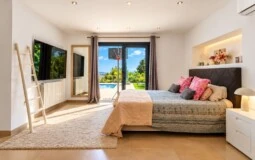 Villa in El Toro - Port Adriano - Sunlit Bedroom with Poolside Views.jpg