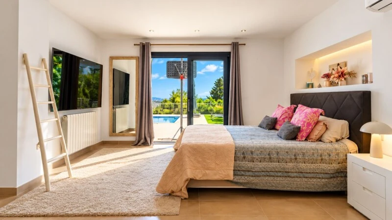 Villa in El Toro - Port Adriano - Sunlit Bedroom with Poolside Views.jpg